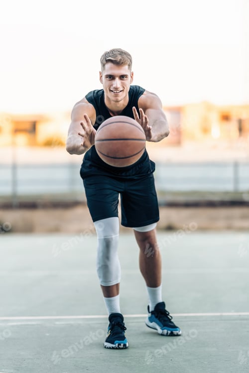 Preview: Basketball player passing the ball outdoors