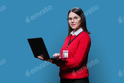 Preview: Young woman with educational center badge laptop on blue background