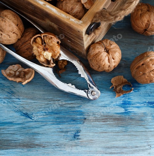 Preview: Fresh walnuts on a blue wooden table