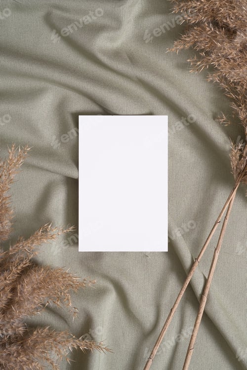 Preview: White blank paper card mockup with pampas dry grass on green neutral colored textile