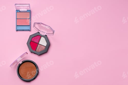 Preview: Set of eyeshadows make up products on pink