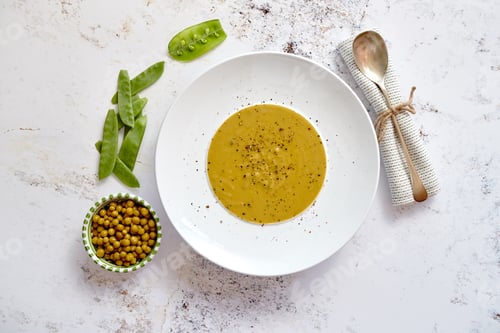 Preview: Creamy soup with green pea in a ceramic white plate
