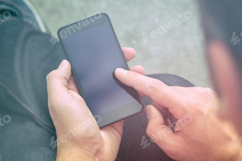 Preview: Man Using Cellphone On A Bench In The Park.