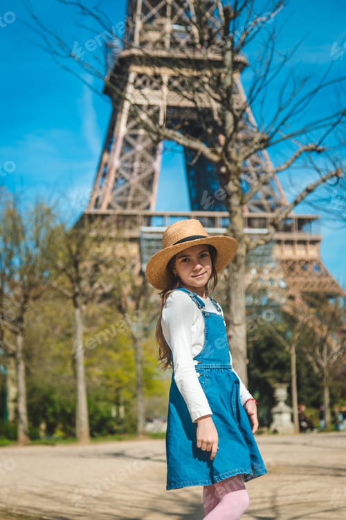 Preview: Children in Paris near the Eiffel Tower. Selective focus.