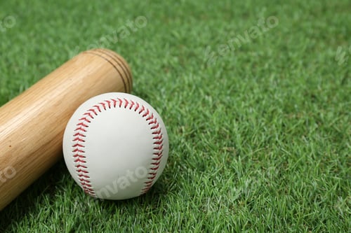Preview: Wooden baseball bat and ball on green grass, closeup. Space for text