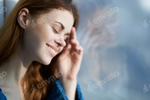 Preview: smiling woman hiding with a blanket near the window rest morning sun