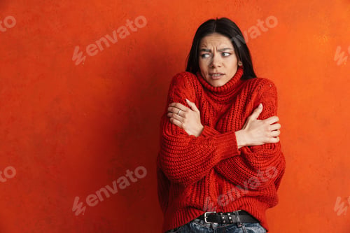 Preview: Young hispanic woman wearing sweater shaking from cold