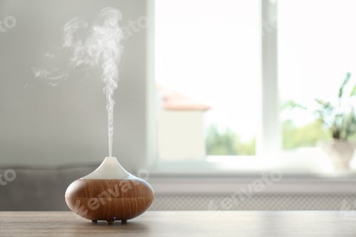 Preview: Modern aroma lamp on table against blurred background with space for text