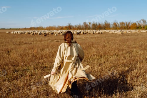 Preview: Young woman in stylish clothes posing in autumn field. Nature, fashion, lifestyle. Travel.
