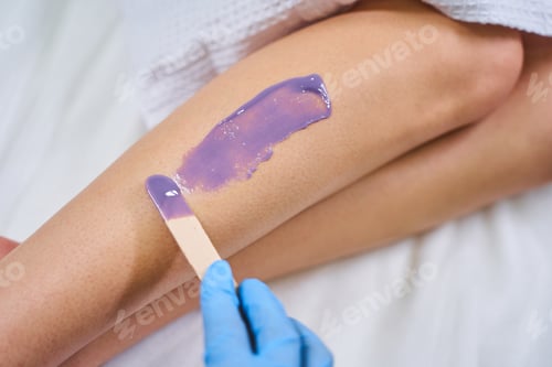 Preview: Close up of leg being covered with wax