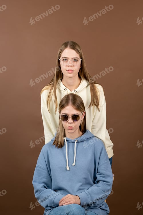 Preview: Two cute blond teenage girl in hoodies and eyewear