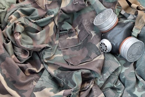 Preview: Stalker soldiers soviet gas mask lies on many green khaki camouflage jackets