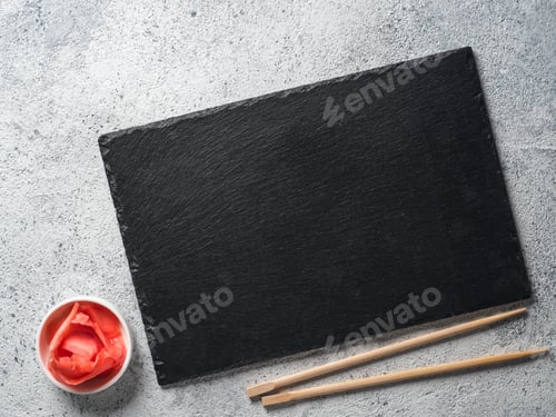 Preview: Empty slate with chopsticks and pickled ginger