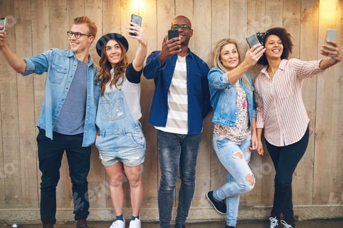 Preview: Happy friends taking selfie at wooden wall