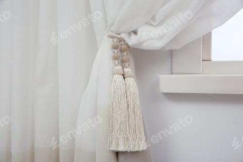 Preview: Elegant window curtain with tieback in room, closeup