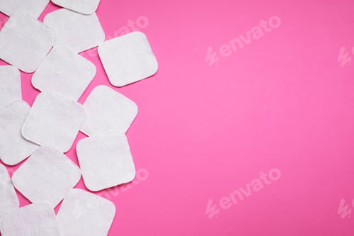 Preview: Many cotton pads on pink background, flat lay. Space for text