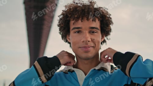 Preview: Smiling teenager posing camera street portrait. Positive zoomer standing alone