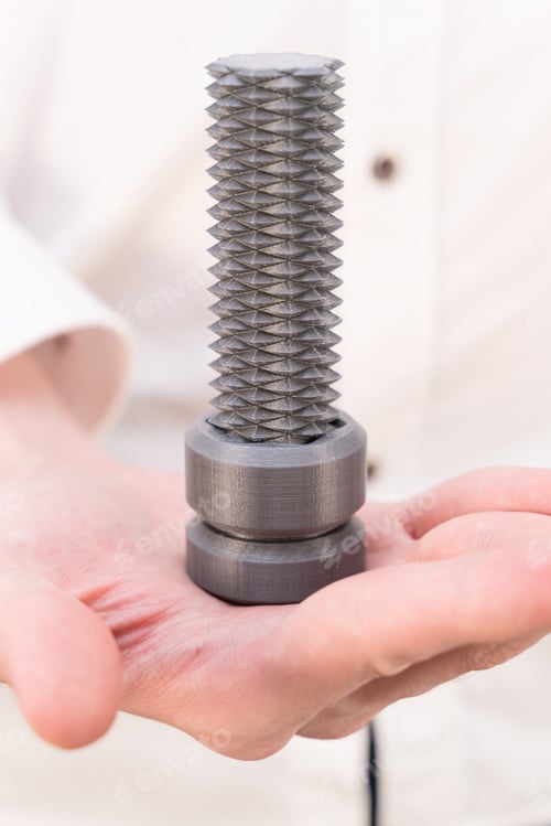 Preview: 3D printed bolt with bi-directional thread in male hands close-up