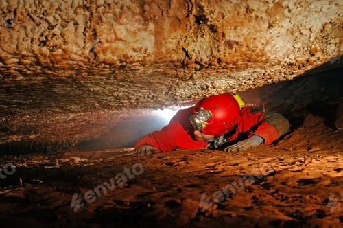 Preview: Narrow cave passage with a cave explorer