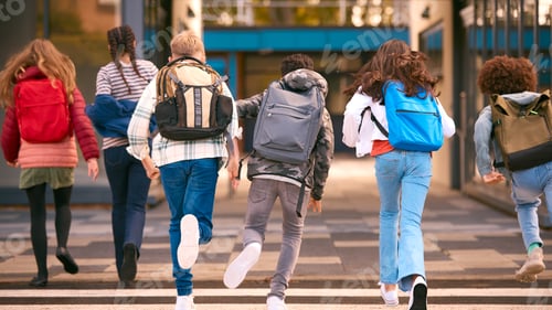 Preview: Group Of Secondary Or High School Pupils Running Away From Camera Outside School Building
