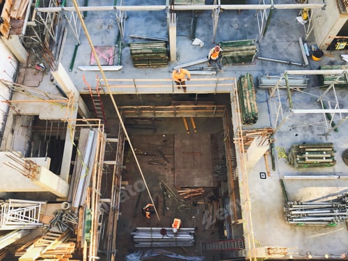 Preview: Looking down at a construction site with workers busy building