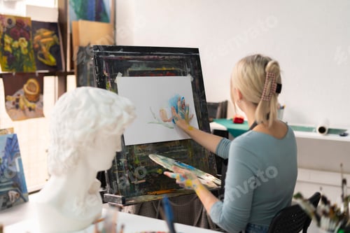Preview: a finger painting, young female artist drawing a picture with her hands
