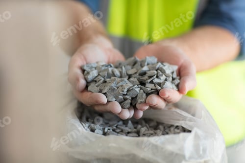 Preview: Worker holding gravel