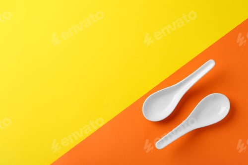 Preview: Miso soup spoons on color background, flat lay. Space for text