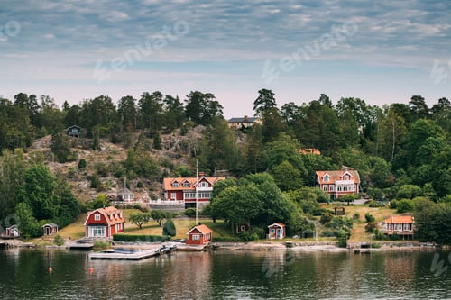Preview: Sweden. Beautiful Red Swedish Wooden Log Cabin House On Rocky Is