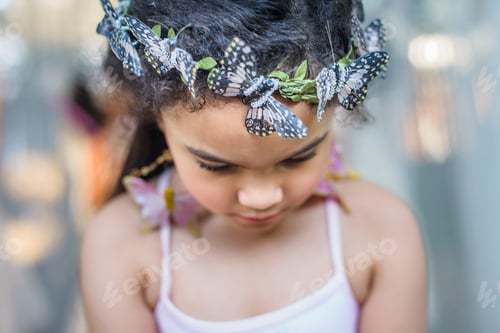 Preview: Portrait of young girl wearing butterflies in hair