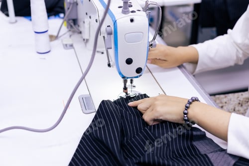 Preview: Tailor working on electric sewing machine