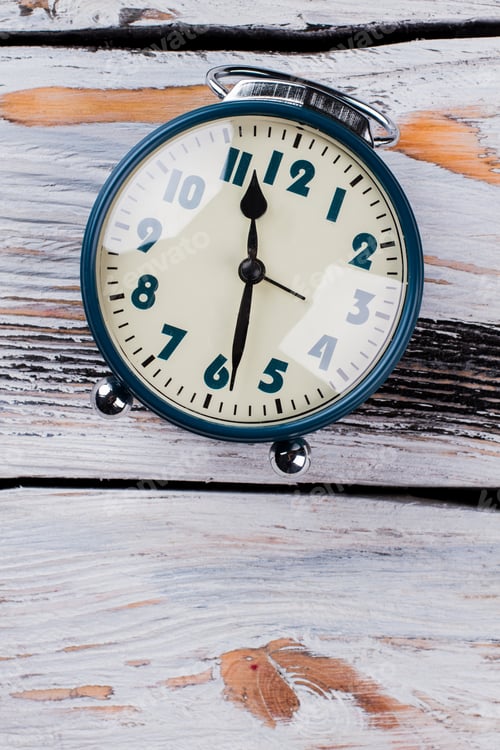 Preview: Vintage alarm clock with reflective glass surface.