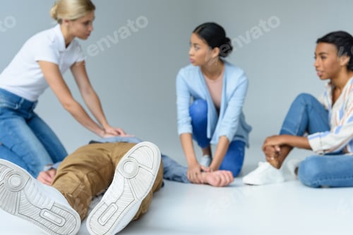 Preview: multiethnic women on first aid training, isolated on grey