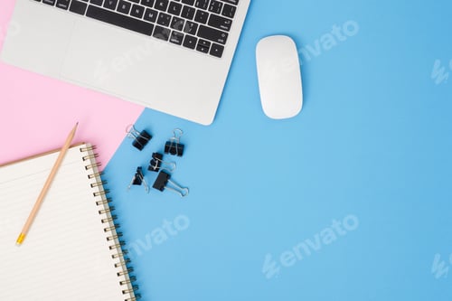 Preview: Top view office desk with laptop, pencil, notebook and plant on blue pink color background.