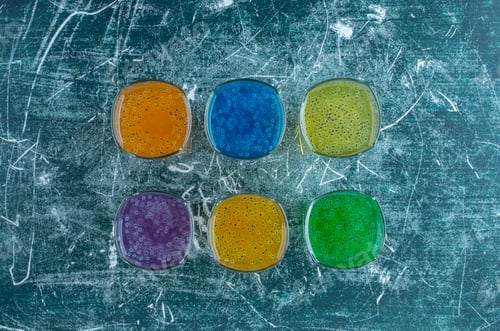 Preview: delicious glasses of juice lined up on the blue background
