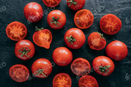 Preview: Close up shot of red tomatoes with water drops on dark background
