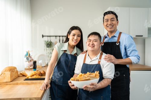 Preview: Portrait of Asian family parents baking bakery with son in kitchen.