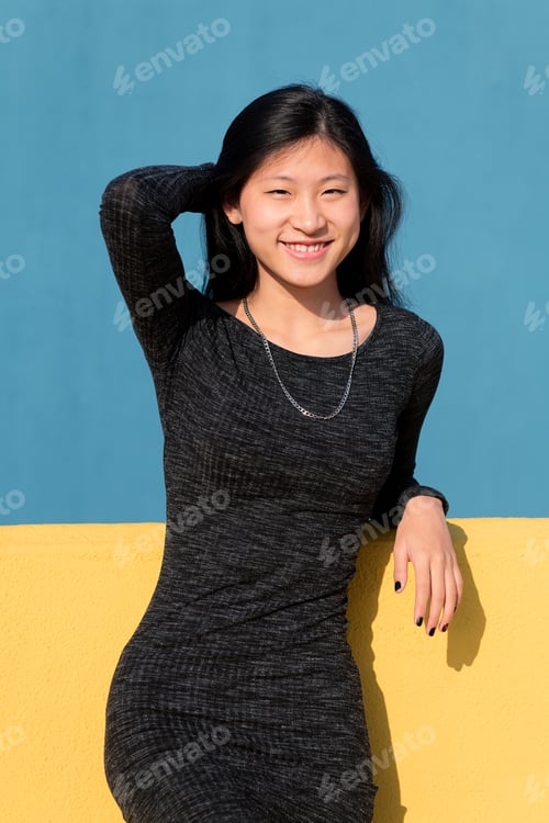Preview: happy smiling asian woman in a tight dress