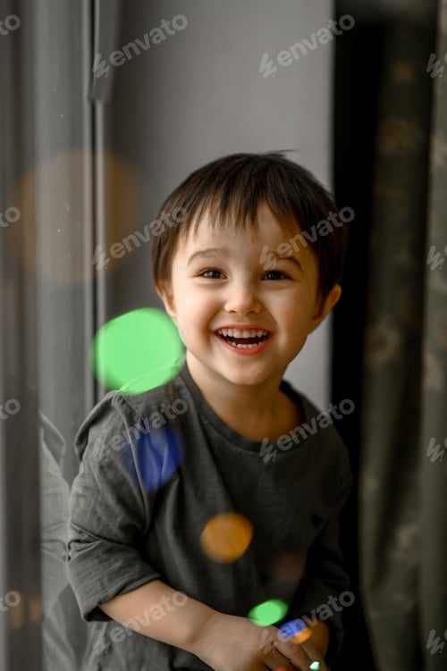 Preview: A three-year-old boy plays with a glowing garland