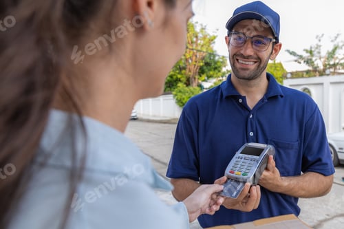 Preview: Delivery express courier young man use giving boxes or Food to woman customer at front home