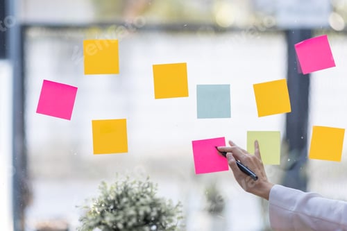 Preview: Business female employee with many conflicting priorities arranging sticky notes commenting and brai