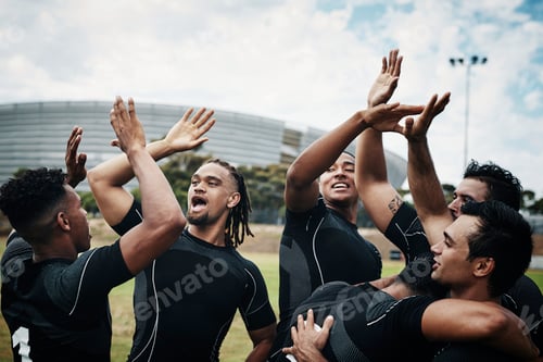 Preview: Cropped shot of a team of rugby players celebrating while standing on the field during the day