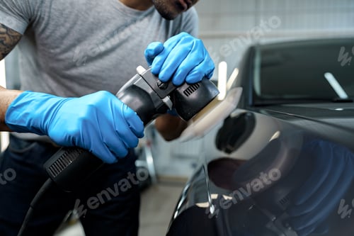 Preview: Car detailing. Male hands with orbital polisher in auto repair shop
