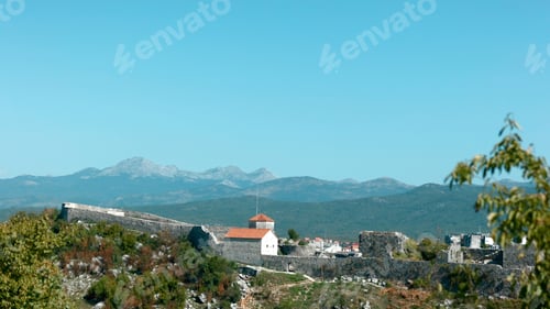 Preview: Bird's-eye view.Creative.Beautiful high green mountains above the city and the ocean and tall trees