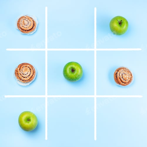 Preview: Green apples vs cinnamon buns in tic tac toe or noughts and crosses game