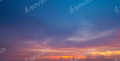Preview: Sunset sky. Abstract nature background. Dramatic blue and orange, colorful clouds at twilight time.
