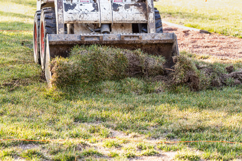 Preview: Small Bulldozer Removing Grass From Yard Preparing For Pool Installation
