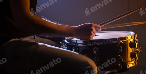 Preview: man playing the snare drum on a beautiful colored background