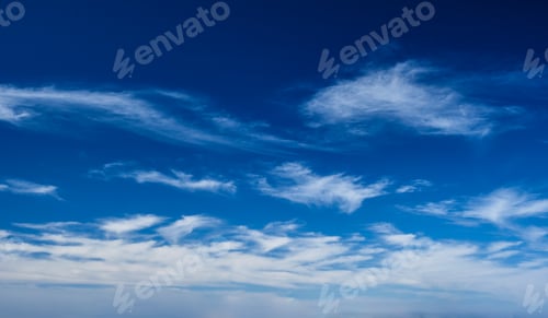 Preview: White Clouds Floating Across a Bright Blue Sky
