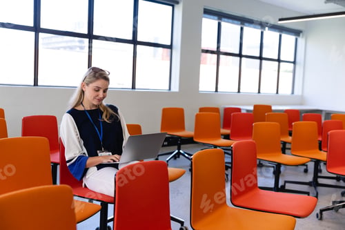 Preview: Caucasian woman in a conference room on her laptop